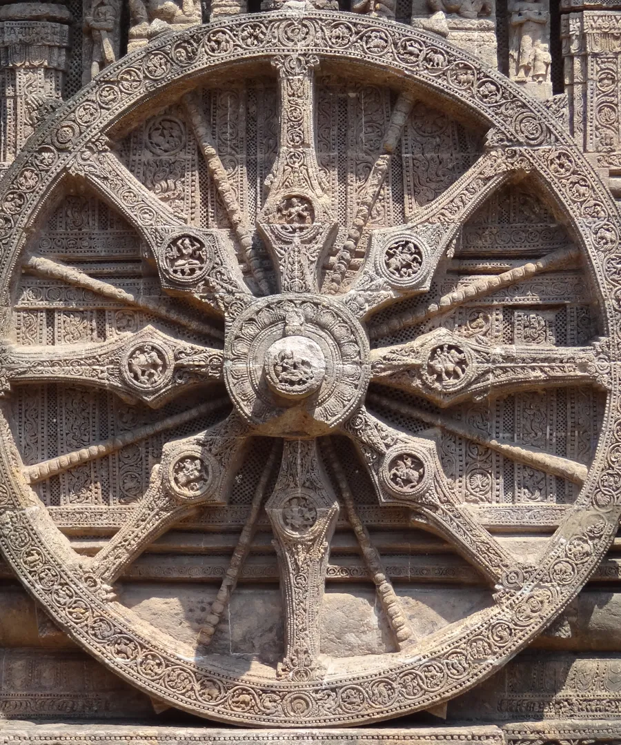 Intricately carved stone chariot wheel at the Konark Sun Temple in Odisha